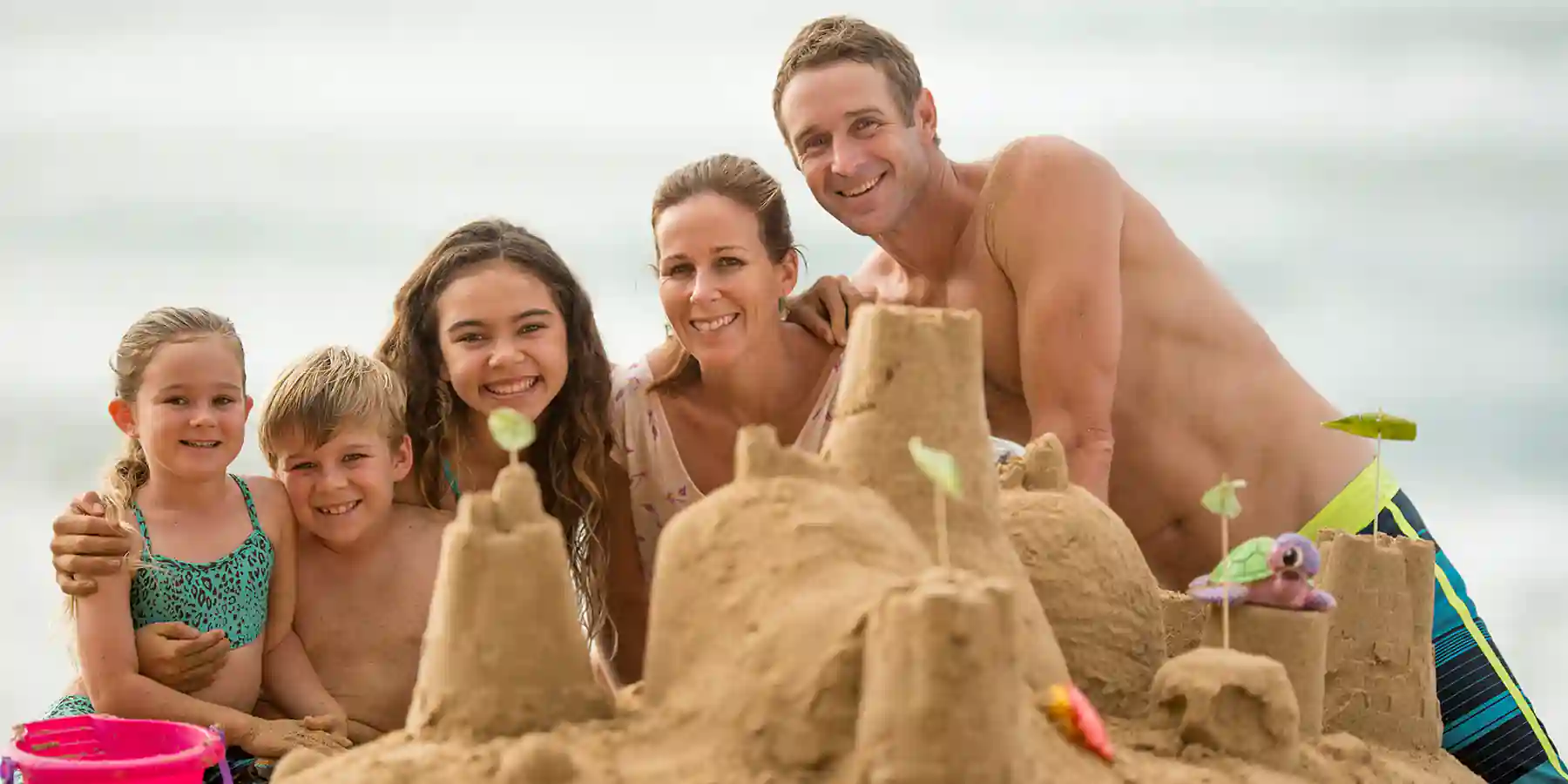 Family Making Sandcastles on the beach